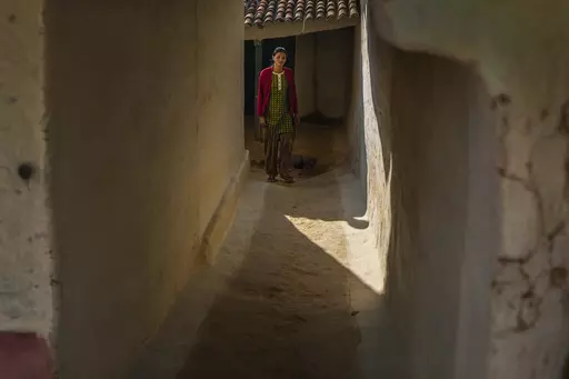 Sickle cell patient Poonam Gond, 19, walks out of her house in Haripur village in Ambikapur district, Chhattisgarh state, India, Monday, March 20, 2023. Gond has crippling pain as a result of poor access to treatment for her disease. Health inequities aren't unique to India, but the sheer scale of its population means that fragile systems are severely stretched. For the poor, this can have devastating consequences. (AP Photo/Rafiq Maqbool)