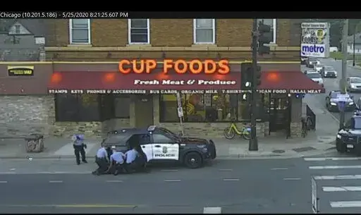 In this image from surveillance video, Minneapolis police Officers from left, Tou Thao, Derek Chauvin, J. Alexander Kueng and Thomas Lane are seen attempting to take George Floyd into custody in Minneapolis, Minn on May 25, 2020. Prosecutors played videos from the scene of Floyd's arrest Tuesday, Jan. 25, 2022 at the federal civil rights trial of three former Minneapolis police officers accused of violating Floyd's civil rights as fellow Officer Derek Chauvin killed him. (Court TV via AP, Pool, 