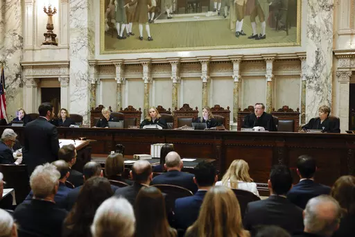 The Wisconsin Supreme Court listens to arguments from Wisconsin Assistant Attorney General Anthony D. Russomanno, representing Gov. Tony Evers, during a redistricting hearing at the state Capitol, Nov. 21, 2023, in Madison, Wis. The liberal-controlled Wisconsin Supreme Court overturned Republican-drawn legislative maps on Friday, Dec. 22, and ordered that new district boundary lines be drawn as Democrats had urged in a redistricting case they hope will weaken GOP majorities. (Ruthie Hauge/The Ca