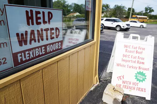 A "Help Wanted" sign is displayed in Deerfield, Ill., Wednesday, Sept. 21, 2022. The year looks to be a much better one for the U.S. economy than business economists were forecasting just a few months earlier, according to a survey released Monday, Feb. 26, 2024. (AP Photo/Nam Y. Huh)