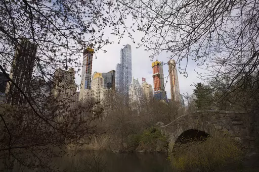 Skyscrapers overlook Central Park and Gapstow Bridge, April 17, 2018, in New York. According to officials, a man stabbed a pit bull to death following a quarrel with the dog's owner in New York City's Central Park. The seriously injured dog was transported to a local animal clinic, where he was euthanized after the stabbing Saturday evening, June 17, 2023, police said. (AP Photo/Mark Lennihan, File)