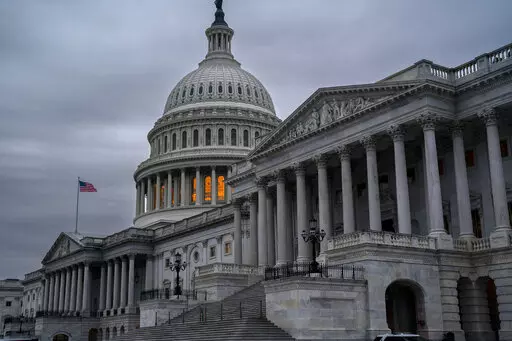 The Senate side of the Capitol is seen in Washington, early Thursday, Dec. 22, 2022, as lawmakers rush to complete passage of a bill to fund the government before a midnight Friday deadline, at the Capitol in Washington, Thursday, Dec. 22, 2022. (AP Photo/J. Scott Applewhite)