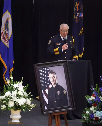 Fargo Police Chief David Zibolski speaks during funeral services for Fargo Police Officer Jake Wallin at Pequot Lakes High School in Pequot Lakes, Minn., on Saturday, July 22, 2023. Wallin, 23, was killed July 14 when a man armed with 1,800 rounds of ammunition, multiple guns and explosives ambushed officers responding to a routine traffic crash. (David Samson/Forum Communications Co. via AP, POOL)