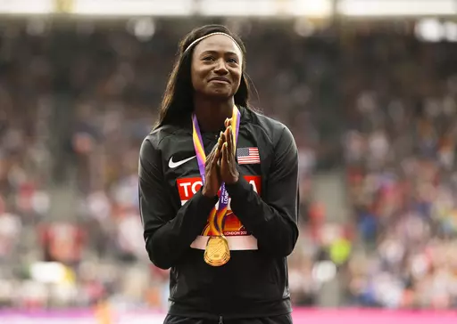 United States' Tori Bowie gestures after receiving the gold medal she won in the women's 100m final during the World Athletics Championships in London, Monday, Aug. 7, 2017. U.S. Olympic champion sprinter Tori Bowie died from complications of childbirth, according to an autopsy report. Bowie, who won three medals at the 2016 Rio de Janeiro Games, was found dead last month. She was 32. (AP Photo/Alastair Grant, File)