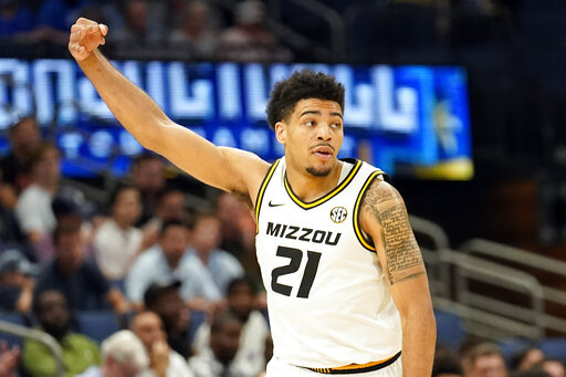 Missouri forward Ronnie DeGray III (21) celebrates after making a three-point basket during the first half of an NCAA men's college basketball Southeastern Conference tournament game against Mississippi Wednesday, March 9, 2022, in Tampa, Fla. (AP Photo/Chris O'Meara)