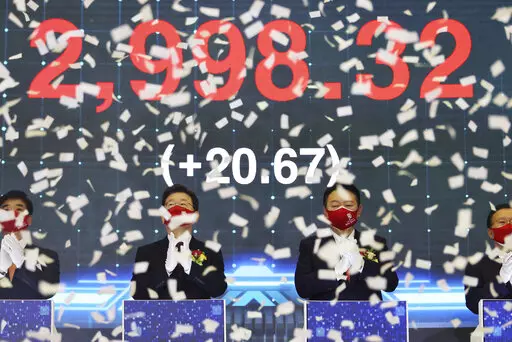 Yoon Suk Yeol, center right, the presidential election candidate of South Korea's main opposition People Power Party (PPP), and Lee Jae-myung, center left, the presidential election candidate of the ruling Democratic Party, attend a ceremony for the first trading day of stock market at the Korea Exchange (KRX) in Seoul, South Korea Monday, Jan. 3, 2022. (Kim Hong-ji/Pool Photo via AP)