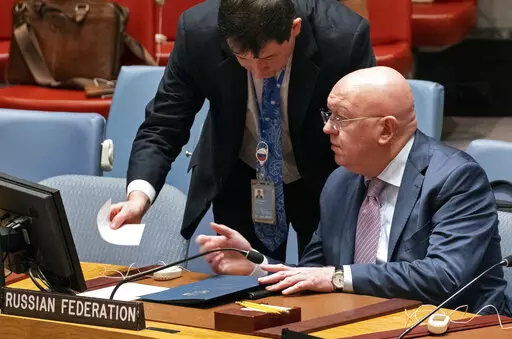 Russian Ambassador to the United Nations Vasily Nebenzya, seated, speaks with Dmitry Polyanskiy, First Deputy Permanent Representative of the Russian Federation, just before Nebenzya addressed the Security Council during a session to discuss the situation with grain shipments from Ukraine at United Nations headquarters, Monday, Oct. 31, 2022. (AP Photo/Craig Ruttle)