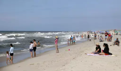 People are seen at Field 3 at Robert Moses State Park in West Islip, N.Y., Tuesday, July 4, 2023. Two swimmers were apparently attacked by sharks off the shores of Long Island on Tuesday, a day after two others reported being attacked while enjoying the water at popular New York beaches. (James Carbone/Newsday via AP)