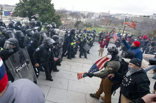 Rioters face off with police at the U.S. Capitol on Jan. 6, 2021, in Washington. A growing number of Capitol riot defendants are pushing to get their trials moved out of Washington. They claim they can't get a fair trial before unbiased jurors in the District of Columbia. (AP Photo/Jose Luis Magana, File)