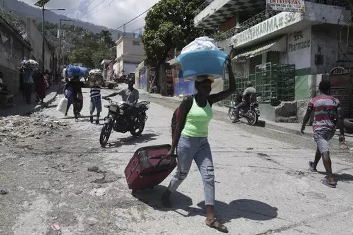 Residents flee their homes to escape clashes between armed gangs in the Carrefour-Feuilles district of Port-au-Prince, Haiti, Aug. 25, 2023. The United Nations Security Council approved on Oct. 2 the deployment of an international armed force to Haiti. (AP Photo/Odelyn Joseph, File)