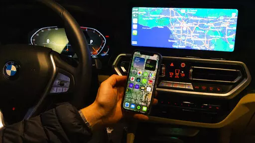 This photo provided by Edmunds is an example of wireless Apple CarPlay. This version removes the need for a messy USB cord and allows drivers to keep their phone in their pocket or neatly charging on a wireless charge pad. (Courtesy of Edmunds via AP)