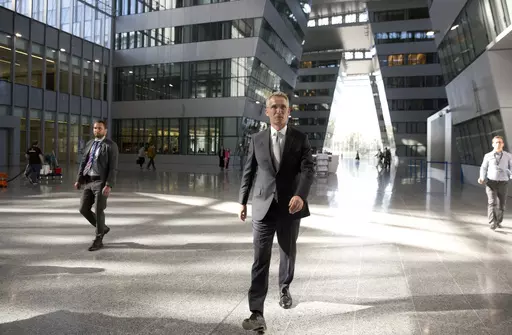 NATO Secretary General Jens Stoltenberg, center, walks in the Agora Hall as he arrives for his first day of work at the new NATO headquarters in Brussels on May 7, 2018. NATO Secretary General Jens Stoltenberg, the top civilian official at the world's biggest security alliance, routinely praises allies for helping Ukraine's troops to fight back. But when he does, Stoltenberg is talking about individual member countries, not NATO as an organization. (AP Photo/Virginia Mayo, File)