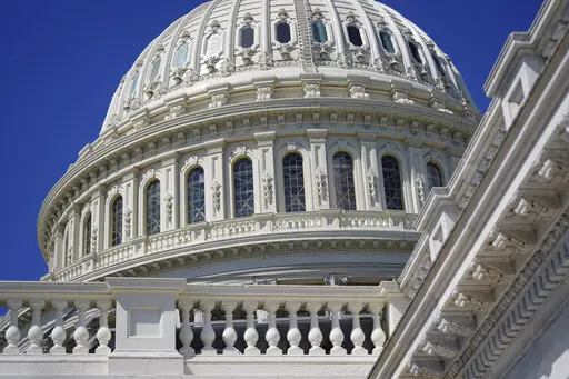 Sun shines on the U.S. Capitol dome in Washington, Aug. 12, 2022. Negotiators have agreed to include more than $12 billion in Ukraine-related aid in a stopgap spending bill that would fund the federal government into mid-December. The package will also provide disaster assistance, including for Jackson, Mississippi, where improvements are needed to the city’s water treatment system. Also in the package is money to help households afford winter heating and to assist Afghans in resettling in the