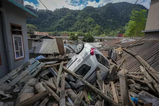 A vehicle lies in the debris of damaged houses in the flood affected area along the Teesta river in Rongpo, east Sikkim, India, Sunday, Oct. 8. 2023. Rescuers continued to dig through slushy debris and ice-cold water in a hunt for survivors after a glacial lake burst through a dam in India’s Himalayan northeast, shortly after midnight Wednesday, washing away houses and bridges and forcing thousands to flee. (AP Photo/Anupam Nath)