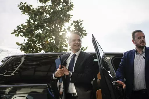 Greece's Prime Minister and New Democracy leader Kyriakos Mitsotakis arrives for an interview at Alpha television station during his election campaign in Athens, Greece, Tuesday, April 25, 2023. (AP Photo/Thanassis Stavrakis)