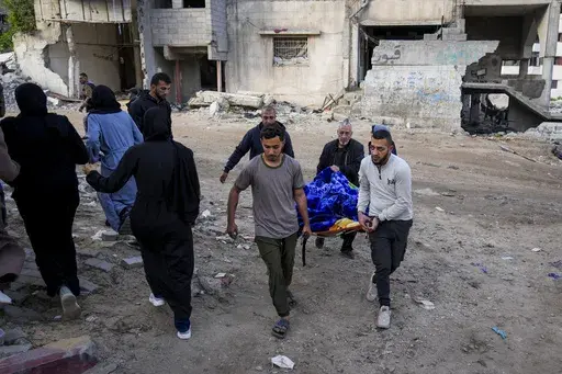 The body of a Palestinian killed in an Israeli army airstrikes is brought to Shifa Hospital in Gaza City, Tuesday, March 18, 2025. (AP Photo/Abdel Kareem Hana)