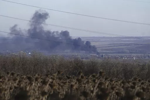 Smoke billows during fighting between Ukrainian and Russian forces in Soledar, Donetsk region, Ukraine, Wednesday, Jan. 11, 2023. Soledar and Bakhmut again highlighted a bitter rift between the top military brass and Yevgeny Prigozhin, a rogue millionaire whose Wagner Group military contractor has played an increasing role in Ukraine. (AP Photo/Libkos, File)