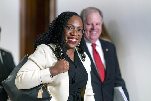 Supreme Court nominee Ketanji Brown Jackson smiles as she arrives for a meeting with Sen. Ben Sasse, R-Neb., a member of the Judiciary Committee, at the Capitol in Washington, March 3, 2022. Former Alabama Sen. Doug Jones has guided Jackson through the process of courting senators and preparing for her confirmation hearing that opens Monday. (AP Photo/J. Scott Applewhite, File)