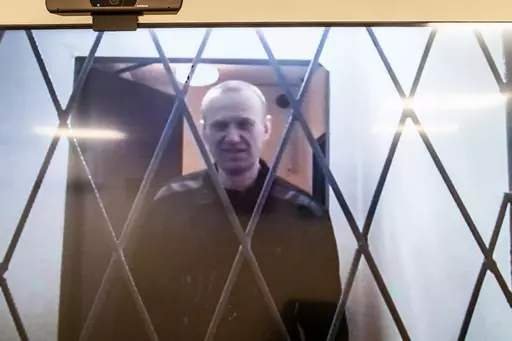 Russian opposition leader Alexei Navalny is seen on a TV screen as he appears in a video link provided by the Russian Federal Penitentiary Service from the courtroom in Kovrov, Vladimir region, about 240 kilometers (150 miles) east of Moscow, Russia, Wednesday, Jan. 10, 2024. Navalny, 47, is jailed on charges of extremism. He had been imprisoned in the Vladimir region of central Russia, but was transferred last month to a "special regime" penal colony — the highest security level of prisons in