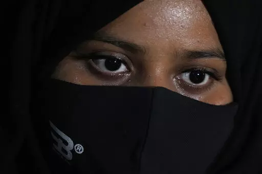Ayesha Imtiaz, an Indian Muslim student barred from school for wearing hijab sits for an interview with the Associated Press at a cafe in Udupi, Karnataka state, India, Thursday, Feb. 24, 2022. Muslim students in this southern Indian state have found themselves at the center of a debate over hijab bans in schools. Imtiaz, said she wears it as a token of devotion to Islam but acknowledged that opinions vary even among Muslim women. "There are so many of my friends who do not wear hijab inside the