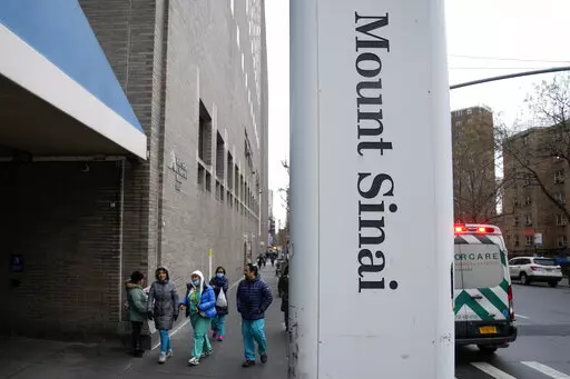 People enter Mount Sinai Hospital in New York, Thursday, Jan. 12, 2023. Two New York City hospitals have reached a tentative contract agreement with thousands of striking nurses that ends the walkout, the nurses' union announced today. (AP Photo/Seth Wenig)