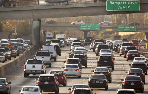 This Dec. 12, 2018, file photo shows traffic on the Hollywood Freeway in Los Angeles. New vehicles sold in the U.S. will have to travel an average of at least 40 miles per gallon of gasoline in 2026 under new rules unveiled by the government. The National Highway Traffic Safety Administration said Friday its fuel economy requirements will undo a rollback enacted under President Donald Trump. (AP Photo/Damian Dovarganes, File)