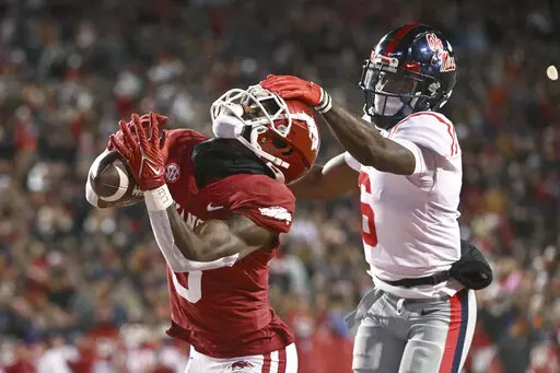 Arkansas wide receiver Matt Landers (3) makes a touchdown catch in front of Mississippi defensive back Miles Battle (6) during the first half of an NCAA college football game Saturday, Nov. 19, 2022, in Fayetteville, Ark. (AP Photo/Michael Woods)
