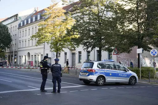 German police officers stand guard in front of the building complex of the Kahal Adass Jisroel community, which houses a synagogue, a kindergarten and a community center, in the center of Berlin, Germany, Wednesday, Oct. 18, 2023. European Union interior ministers met Thursday, Oct. 19, 2023, to discuss how to manage the impact of the war between Israel and Hamas on the bloc, after a firebomb assault on a Berlin synagogue and killings in Belgium and France by suspected Islamist extremists. (AP P