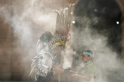 Mexica dancers burn incense during a ceremony commemorating the 503rd anniversary of the fall of the Aztec empire's capital, Tenochtitlan, in Mexico City, Tuesday, Aug. 13, 2024. (AP Photo/Eduardo Verdugo)