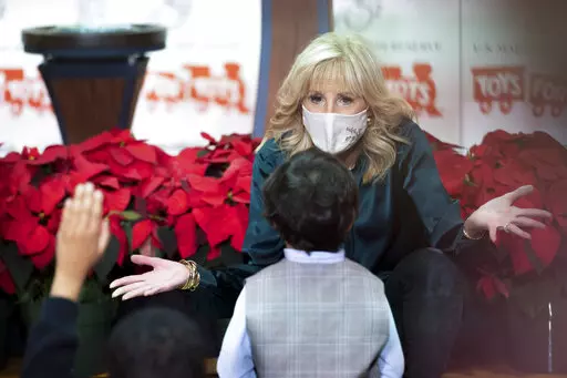 First lady Jill Biden talks with a young boy while they participate in a Toys for Tots sorting event at Joint Base Myer-Henderson Hall, in Arlington, Va., Friday, Dec. 10, 2021. (AP Photo/Cliff Owen)