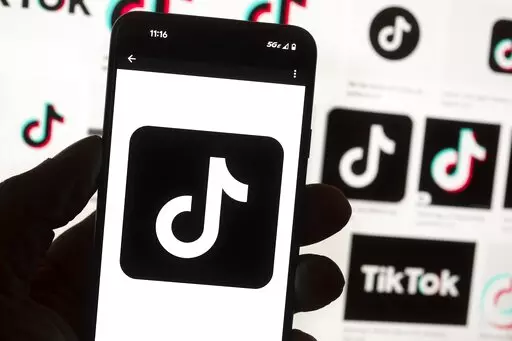 The TikTok logo is seen on a cellphone on Oct. 14, 2022, in Boston. TikTok says every account held by a user under the age of 18 will automatically be set to a 60-minute daily screen time limit in the coming weeks amid growing concerns about the app's security. (AP Photo/Michael Dwyer, File)