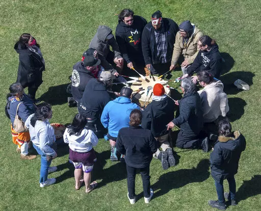 A group of singers from the Wabanaki Confederacy drum and sing before a news conference in support of the tribal sovereignty bills Wednesday, April 20, 2022, in front of the Maine State House in Augusta, Maine. (Joe Phelan/The Kennebec Journal via AP)