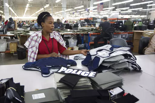 Laurette Eugene assembles a body armor vest at the Point Blank Body Armor factory in Pompano Beach, Fla., Sept. 19, 2014. When a shooter attacked a supermarket in Buffalo, New York,May 14, 2022, its security guard tried to stop him. At least one of the guard's shots hit the gunman, but it didn’t stop the deadly rampage because the gunman was wearing body armor. (AP Photo/J Pat Carter, File)