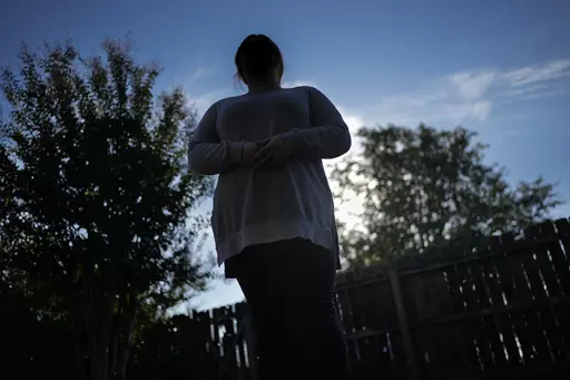 Ramona stands for a portrait Tuesday, Oct. 10, 2023, in Cordova, Tenn. The COVID-19 pandemic, and the conspiracy theories it spawned, would change Ramona's life forever, sending her down a dark path of paranoia and isolation. (AP Photo/George Walker IV)