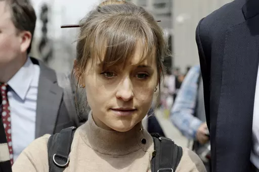 Television actor Allison Mack leaves federal court in the Brooklyn borough of New York, April 8, 2019, after pleading guilty to racketeering charges in a case involving a cult-like group based in upstate New York called NXIVM. Mack has been released from a California prison, according to a government website. Online records maintained by the Federal Bureau of Prisons said she was released Monday, July 3, 2023. (AP Photo/Mark Lennihan, File)