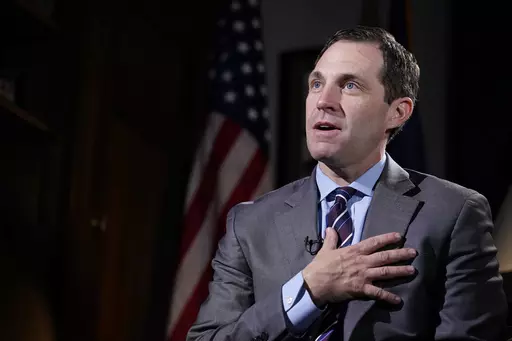 Rep. Jason Crow, D-Colo., talks during an interview with The Associated Press in his office on Capitol Hill in Washington, Dec. 15, 2021. Two decades ago, Crow was a 24-year-old platoon leader in the American invasion of Iraq. Platoon members carried gas masks and gear to wear over their uniforms to protect them from the chemical weapons the U.S. believed – wrongly – that Iraqi forces might use against them. Today, Crow sits on committees that oversee the U.S. military and intelligence agenc