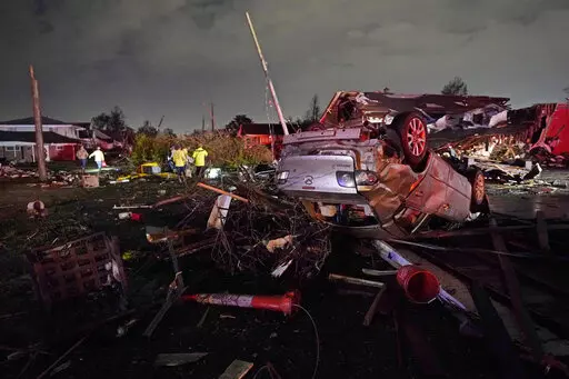 A car is flipped over after a tornado tore through the area in Arabi, La., Tuesday, March 22, 2022, in a part of the city that had been heavily damaged by Hurricane Katrina 17 years earlier. A United Nations report released on Monday, April 25, 2022, says disasters are on the rise are just going to get worse. A new UN report says the number of disasters, from climate change to COVID-19, are going to jump to about 560 a year by 2030. (AP Photo/Gerald Herbert, File)