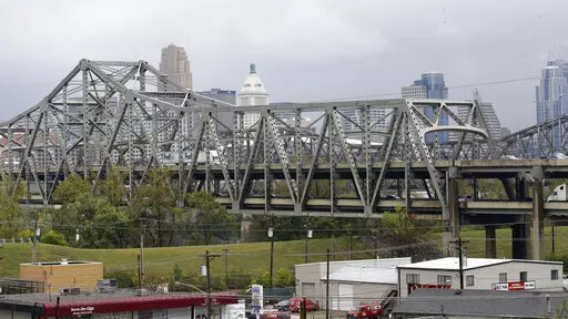 Traffic on the Brent Spence Bridge passes in front of the Cincinnati skyline while crossing the Ohio River to and from Covington, Ky., Oct. 7, 2014. According to a recent announcement by Kentucky and Ohio they will receive more than $1.63 billion in federal grants to help build a new Ohio River bridge near Cincinnati and improve the existing overloaded span there, a heavily used freight route linking the Midwest and the South. (AP Photo/Al Behrman, File)