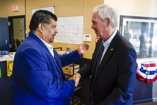 Wisconsin Republican U.S. Senate candidate Ron Johnson and Pastor Marty Calderon shake hands at a local Republican election office in Milwaukee, on Saturday, Oct. 8, 2022. In two decades of street outreach on Milwaukee’s south side, Calderon has offered Bible study, gang prevention, a safe place to stay for those battling addiction, and help getting jobs for those newly released from prison. But as he’s watched rising crime threaten those efforts to “clean up” his impoverished neighborho