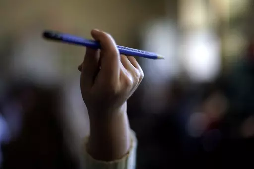 A student raises her hand to ask a question in her third grade classroom at Highland Elementary School in Columbus, Kan., on Monday, Oct. 17, 2022. Across the country, federal data show, the disruptions wrought by the pandemic were accompanied by widespread learning setbacks, even in states that saw students return quickly to in-person learning. Among those showing the largest learning losses are this year’s crop of third graders, who were in kindergarten when the pandemic hit, a foundational 