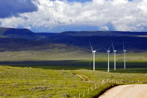 Clouds cast shadows near wind turbines at a wind farm along the Montana-Wyoming state line on June 13, 2022. The Biden administration is proposing a new permitting program for wind energy turbines, power lines and other projects that kill bald and golden eagles. (AP Photo/Emma H. Tobin, File)