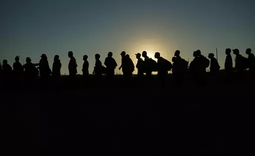 Migrants who crossed the Rio Grande and entered the U.S. from Mexico are lined up for processing by U.S. Customs and Border Protection, Saturday, Sept. 23, 2023, in Eagle Pass, Texas. A federal judge in Texas on Friday, March 8, 2024, upheld a key piece of President Joe Biden’s immigration policy that allows a limited number of migrants from four countries to enter the U.S. on humanitarian grounds, dismissing a challenge from Republican-led states that said the program created an economic burd
