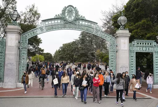 Students make their way through the Sather Gate near Sproul Plaza on the University of California, Berkeley, campus March 29, 2022, in Berkeley, Calif. The Free Application for Federal Student Aid is available for the 2024-2025 school year, three months later than usual. (AP Photo/Eric Risberg, File)