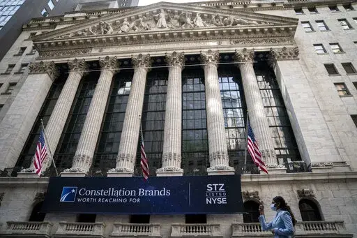 Pedestrians pass the New York Stock Exchange, Thursday, May 5, 2022, in the Manhattan borough of New York.  Stocks are opening lower on Wall Street, Friday, Sept. 30, on pace to close out another losing month.  (AP Photo/John Minchillo, File)