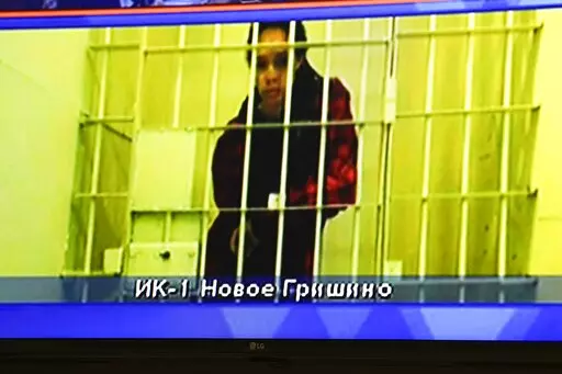 WNBA star and two-time Olympic gold medalist Brittney Griner is seen on the bottom part of a TV screen as she waits to appear in a video link provided by the Russian Federal Penitentiary Service a courtroom prior to a hearing at the Moscow Regional Court in Moscow, Russia, Tuesday, Oct. 25, 2022. A Russian court on Tuesday started hearing American basketball star Brittney Griner's appeal against her nine-year prison sentence for drug possession. (AP Photo/Alexander Zemlianichenko)