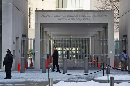 A security official walks in front of the entrance to the national headquarters of the Bureau of Alcohol, Tobacco, Firearms and Explosives on Jan. 23, 2014, in Washington. New data from the bureau shows that 68,000 illegally trafficked firearms in the U.S. came through unlicensed dealers who aren't required to perform background checks over a five year report that was released Thursday, April 4, 2024. (AP Photo/Charles Dharapak, File)
