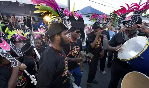 In this photo provided by the Florida Keys News Bureau, Junkanoo dancers jam on Petronia Street Friday, Oct. 20, 2023, in Key West, Fla., during the Goombay Festival that marks the beginning of Fantasy Fest, the subtropical island's annual costuming and masking festival. A 10-day schedule of masquerades, elaborate parties and costume competitions continues through Sunday, Oct. 29. The festival is themed "Uniforms and Unicorns … 200 Years of Sailing into Fantasy" to salute the Florida Keys' 202