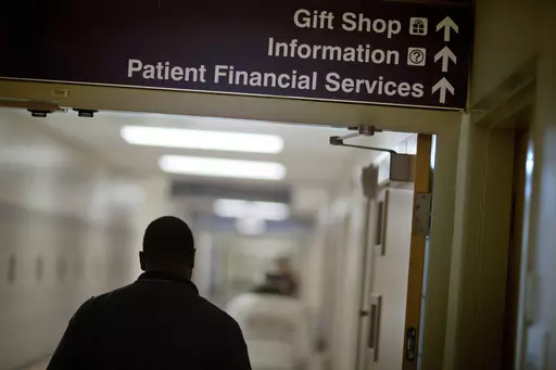 A sign points visitors toward the financial services department at a hospital, Friday, Jan. 24, 2014. Medicaid coverage will end for millions of Americans in 2023, and that pushes many into unfamiliar territory: the health insurance marketplace. (AP Photo/David Goldman, File)