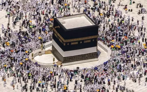 Muslim pilgrims walk around the Kaaba, the cubic building at the Grand Mosque, during the annual hajj pilgrimage, in Mecca, Saudi Arabia, on July 10, 2022. Islam's annual hajj pilgrimage in Saudi Arabia will return to pre-pandemic levels in 2023 after restrictions saw the annual religious commemoration curtailed over concerns about the coronavirus, authorities say. (AP Photo/Amr Nabil, File)